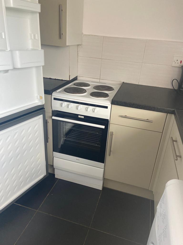 A functional kitchenette featuring essential ap...