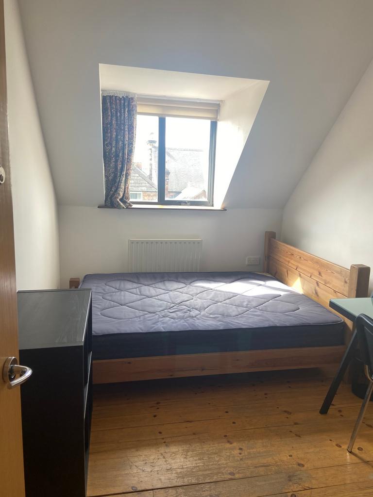 A cozy double bedroom with natural light, perfe...