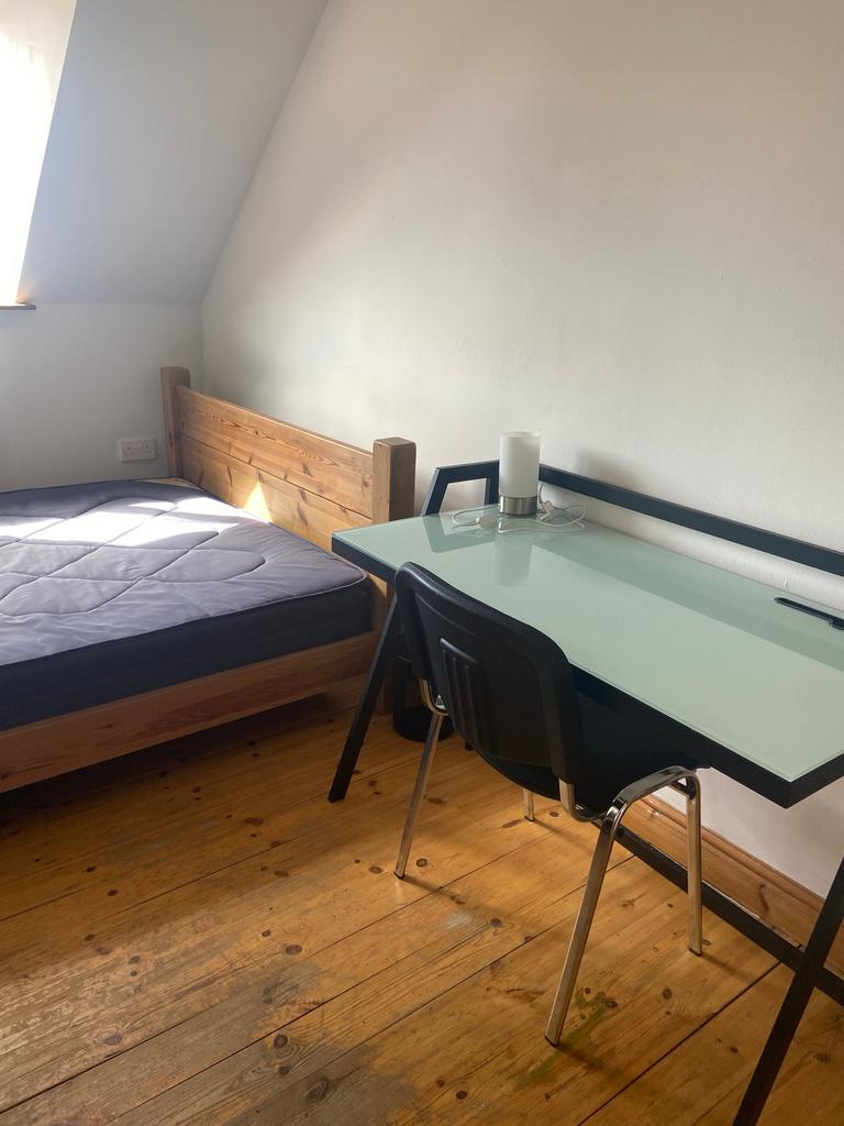 A cozy double bedroom with natural light and a ...