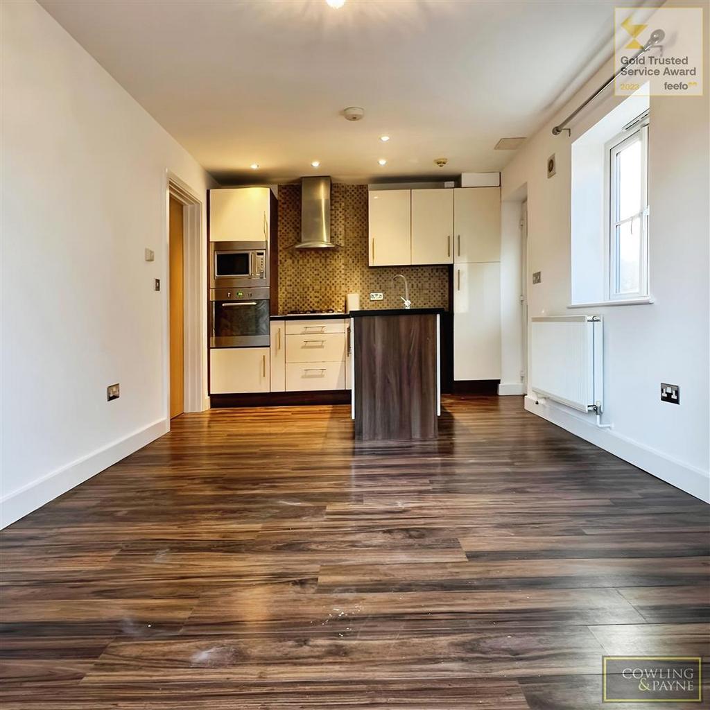 Living room leading to open plan kitchen