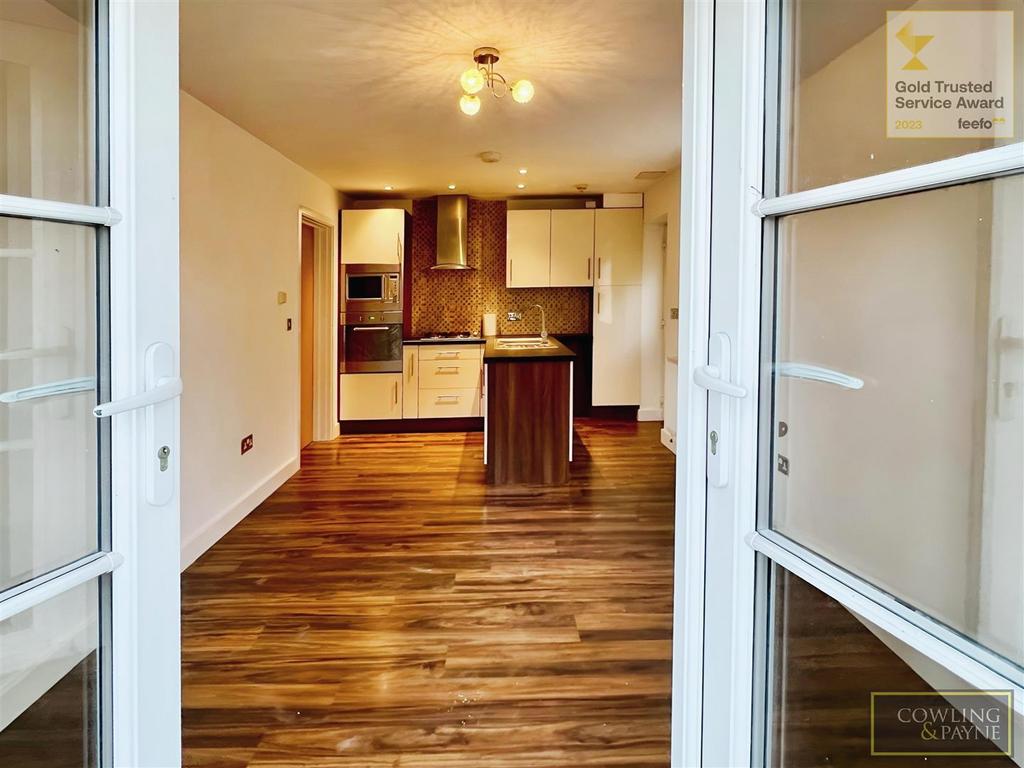 Living room leading to open plan kitchen