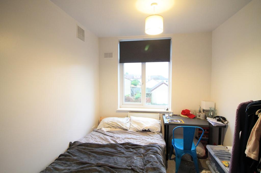 A cozy double bedroom with natural light and a ...