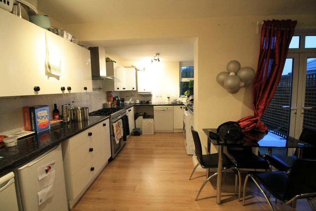 A spacious and tidy kitchen with modern applian...