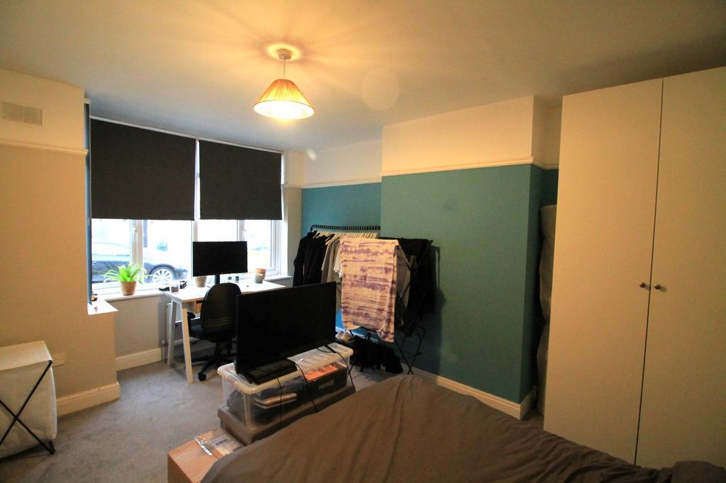 A cozy double bedroom featuring good natural li...