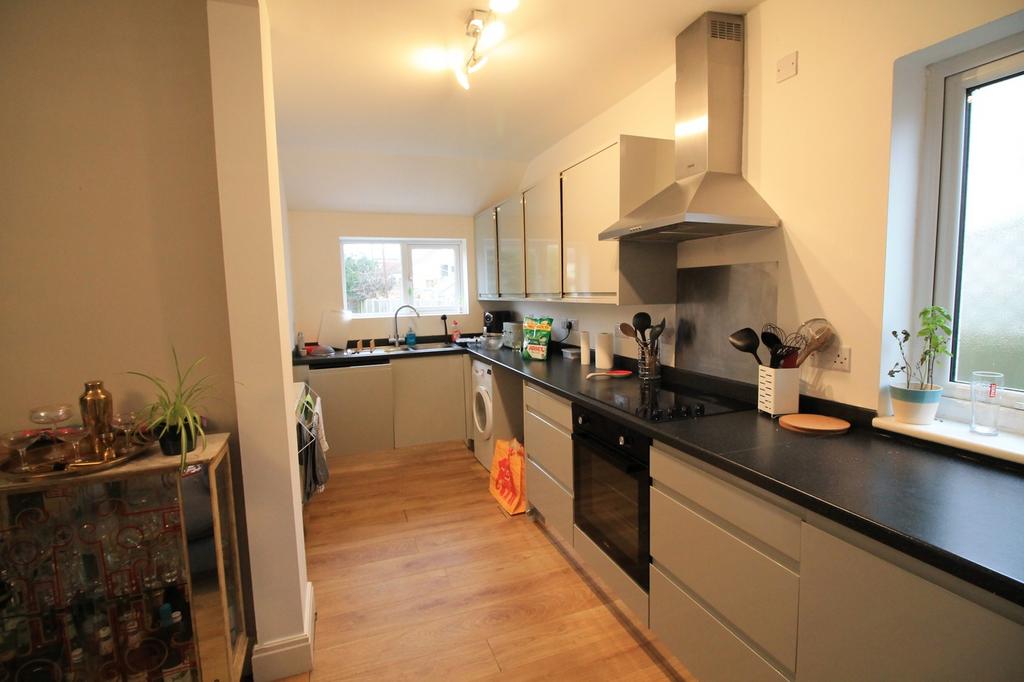 A spacious and modern kitchen featuring ample s...