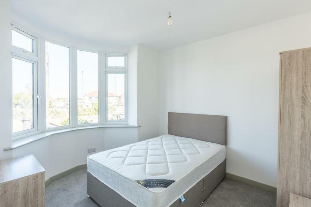 A bright and spacious double bedroom with large...