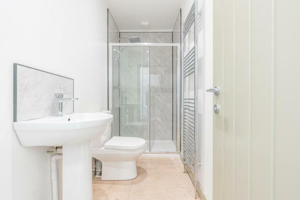 A modern and pristine bathroom featuring a styl...