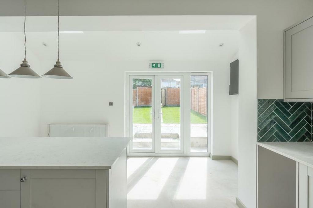 A bright and spacious kitchen with modern desig...