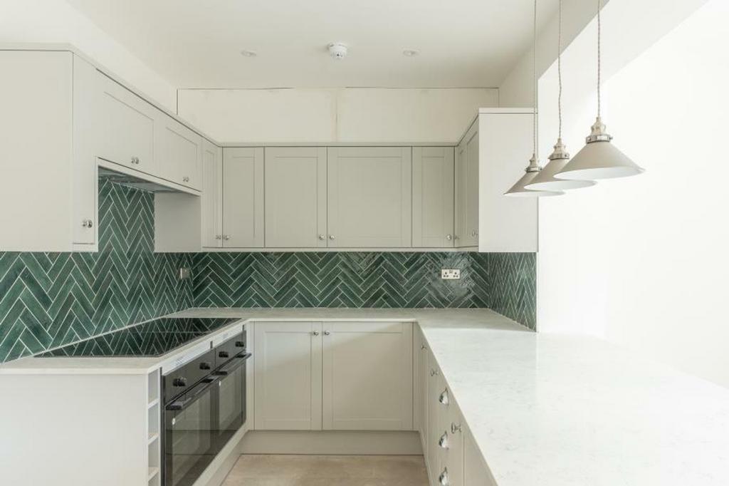 A modern and spacious kitchen featuring stylish...