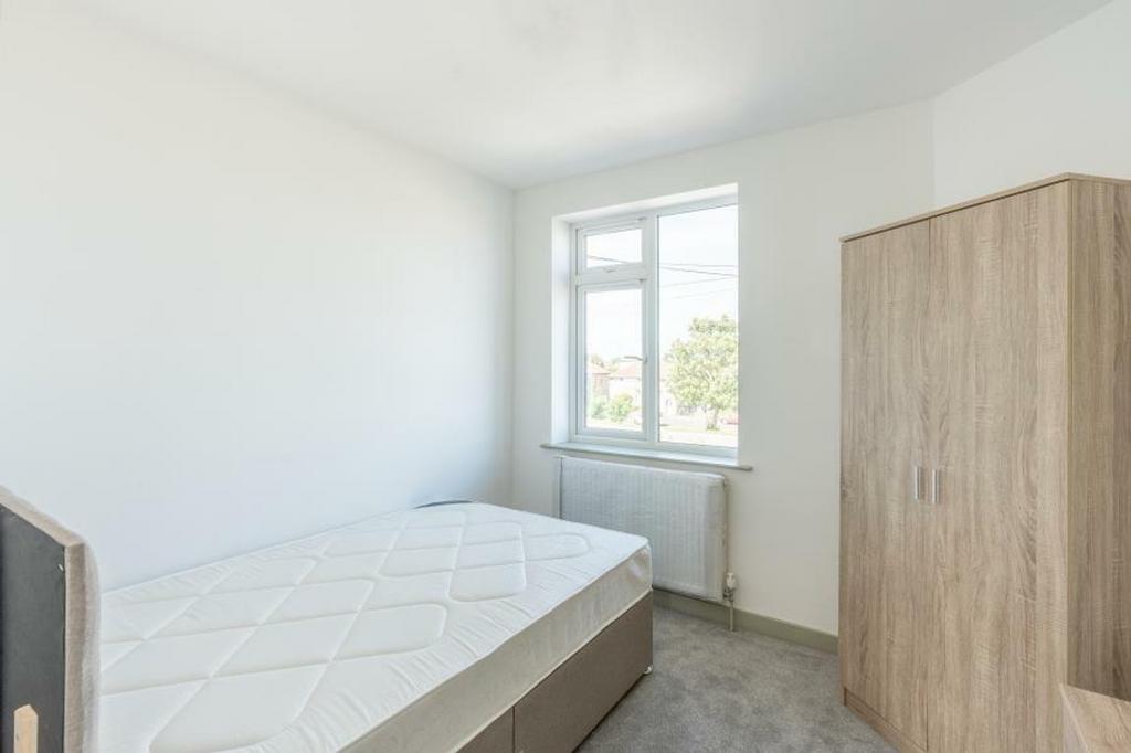 A bright and airy double bedroom with ample nat...