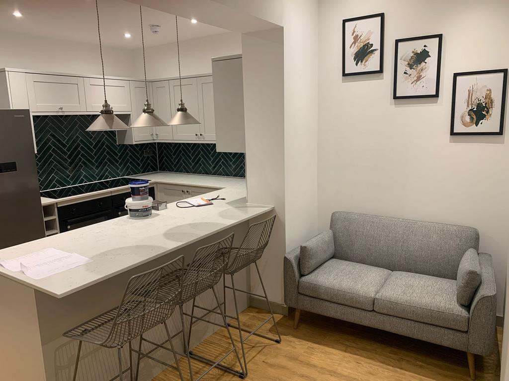 A modern kitchenette featuring stylish decor an...