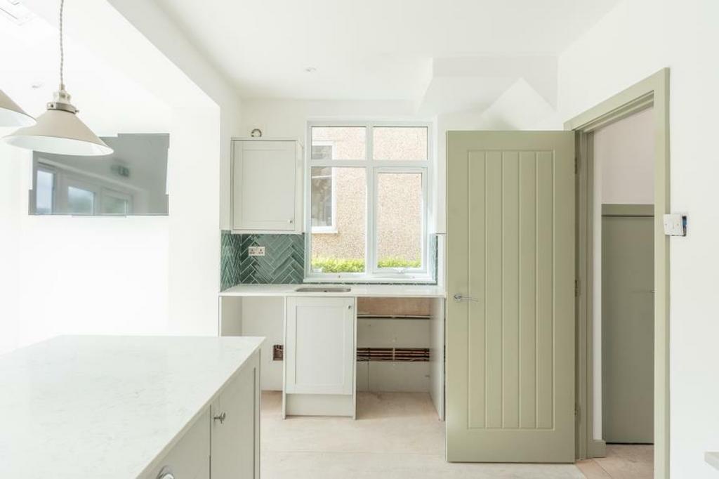 A bright and modern kitchenette with a clean de...