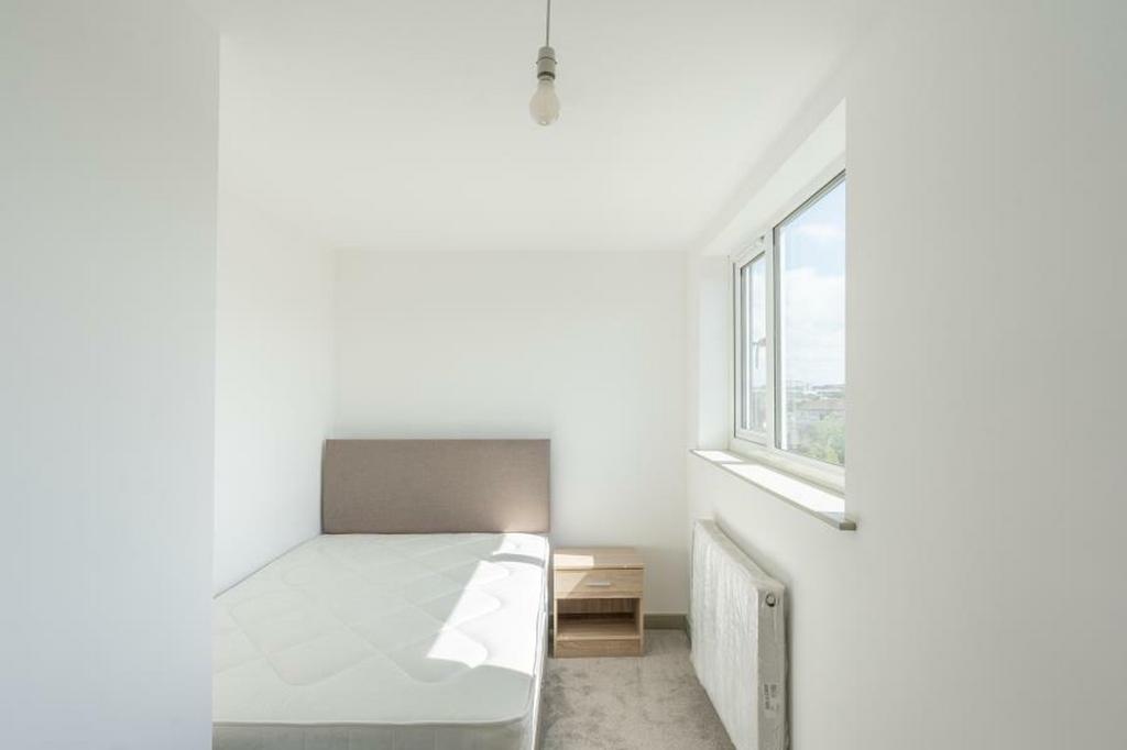 A bright and inviting double bedroom with ample...