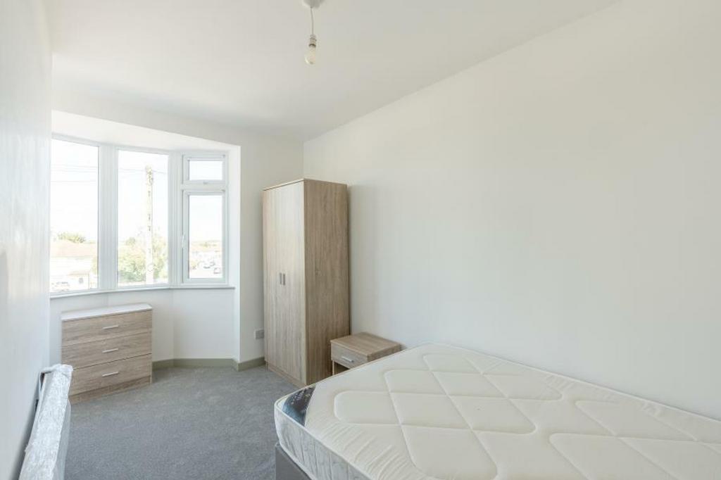 A bright and spacious double bedroom with ample...