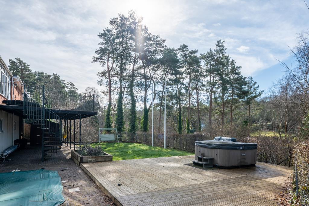 Decking area with hot tub looking towards trees