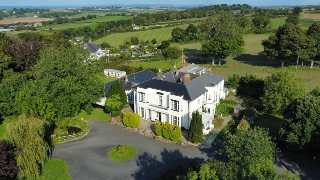 Aerial view of the property, gardens and driveway