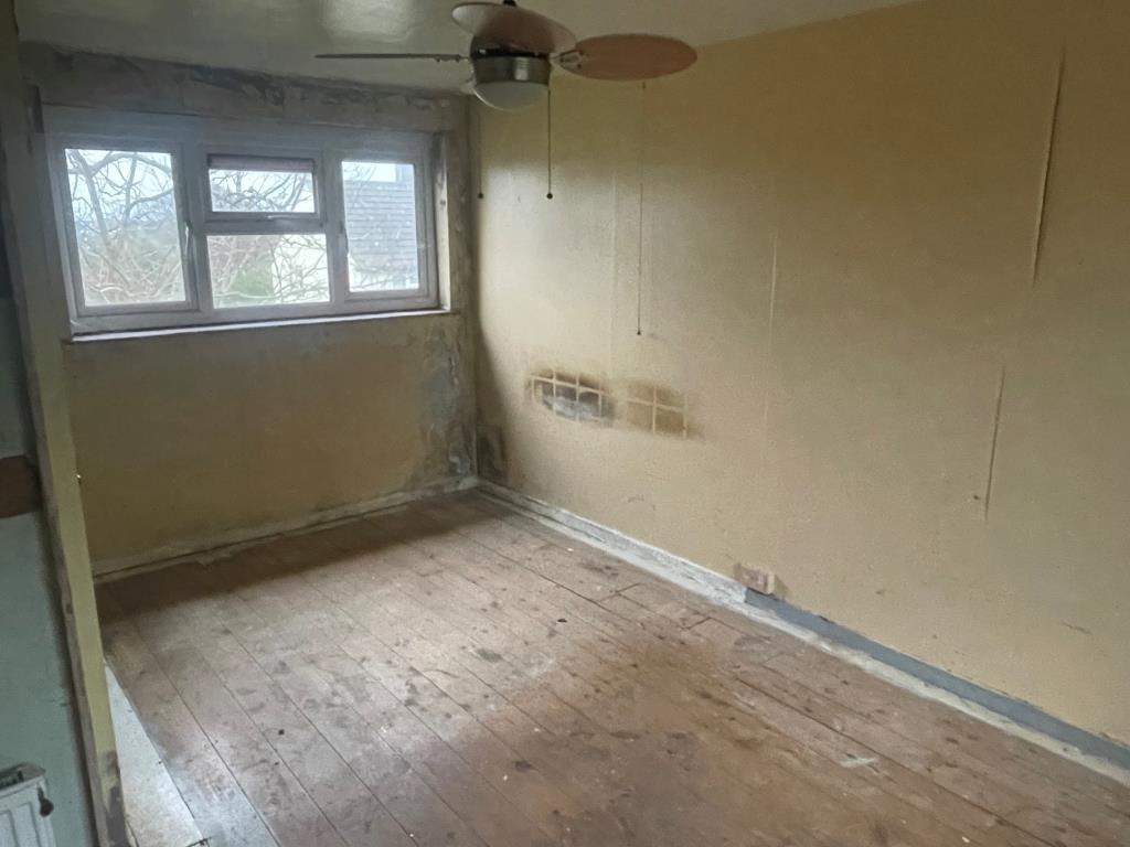 First floor bedroom with exposed floorboards