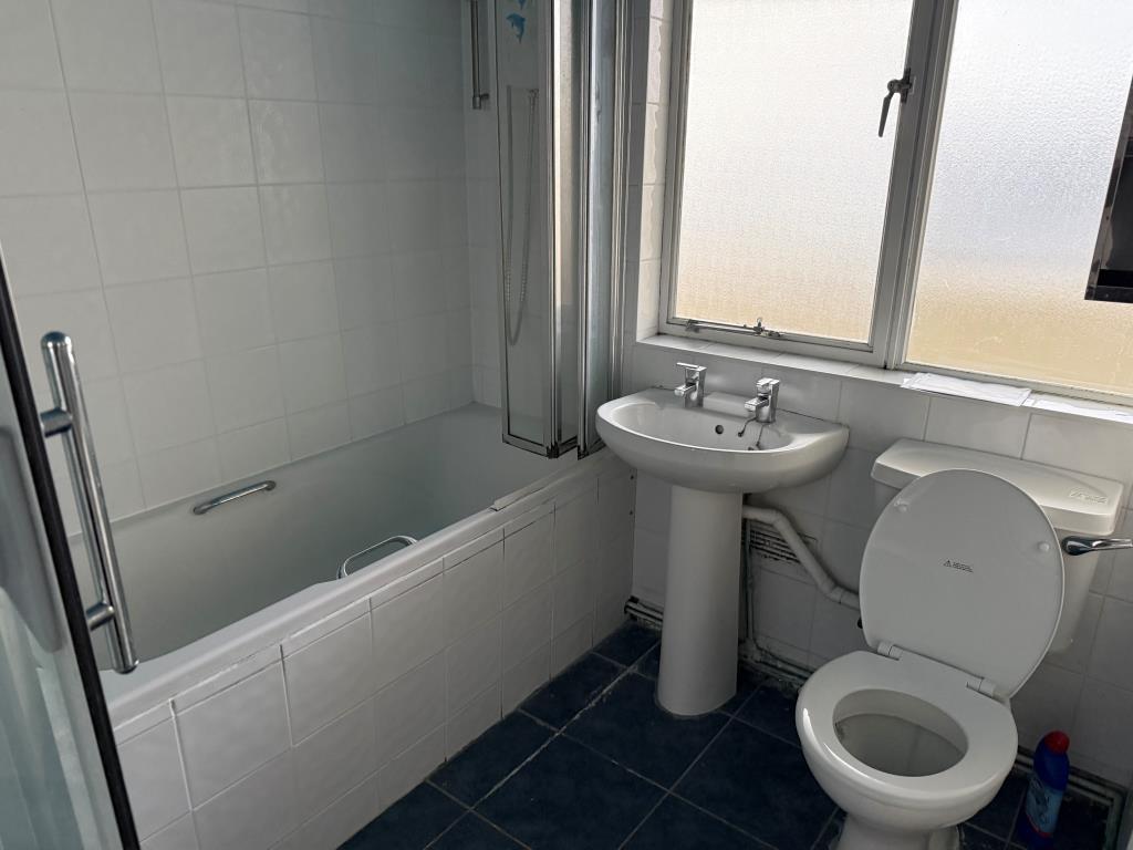 Bathroom with white suite and window