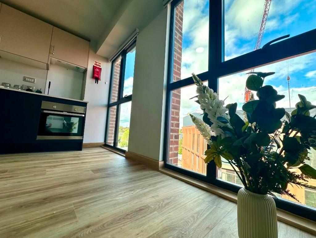 A bright and modern kitchenette with large wind...