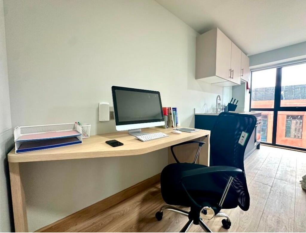 A bright and tidy communal workspace featuring ...