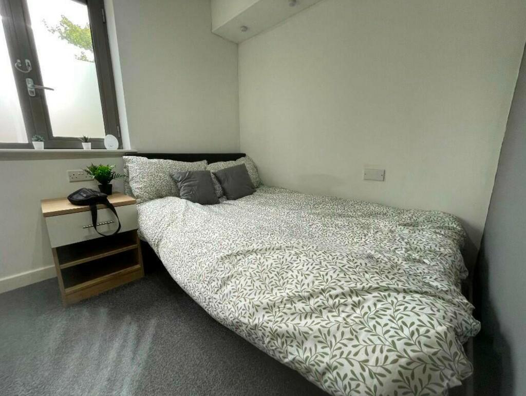 A bright and tidy double bedroom featuring comf...