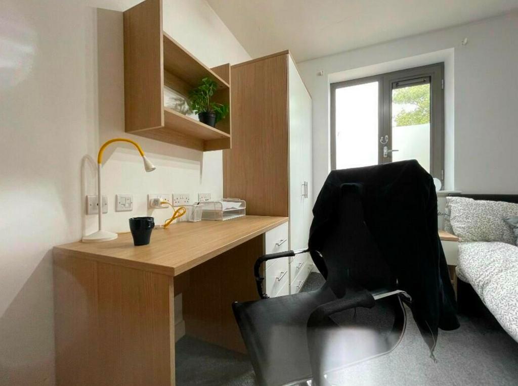 A bright and tidy double bedroom featuring a st...