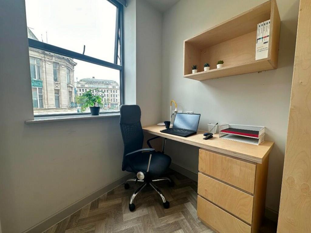 A bright and tidy communal workspace featuring ...