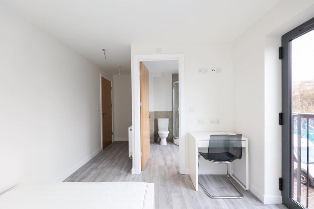 A bright and spacious double bedroom featuring ...