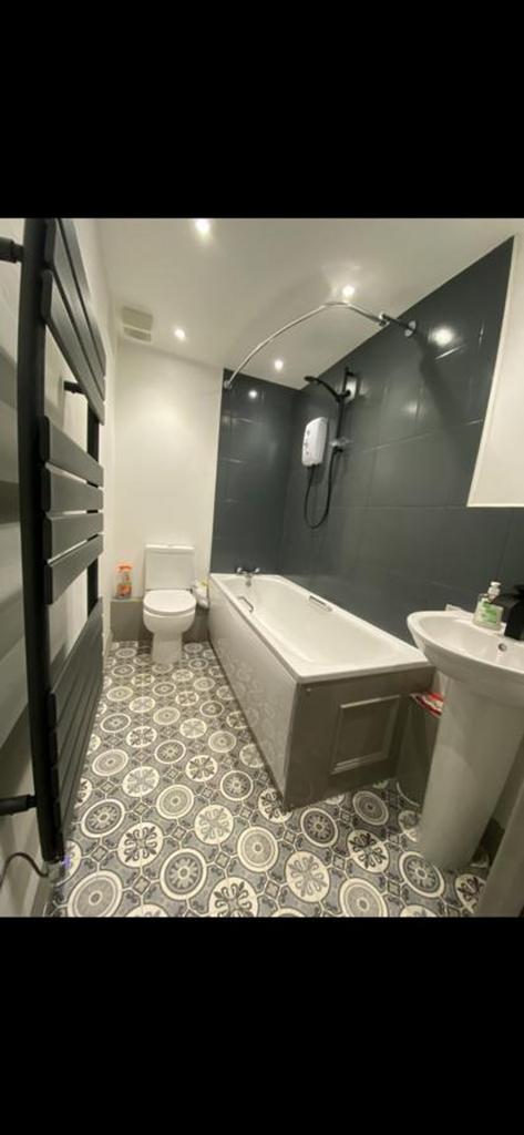 A spacious and modern bathroom featuring a styl...