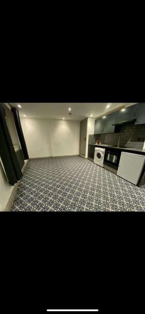 A spacious and modern kitchenette with plenty o...