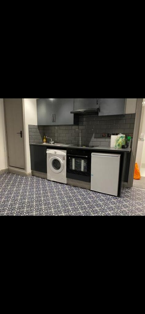 A modern kitchenette with essential appliances,...