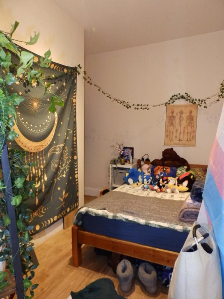 A cozy double bedroom with personal touches and...