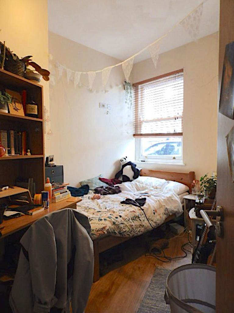 A cozy double bedroom with a warm atmosphere, p...