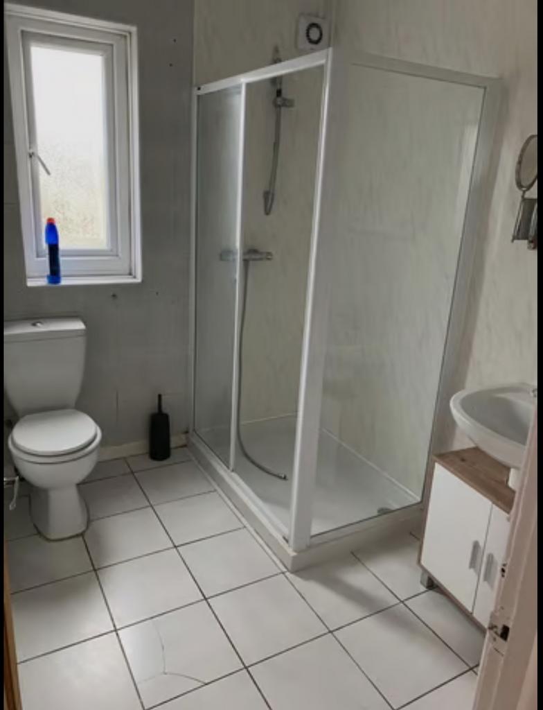 A bright and tidy bathroom featuring a spacious...