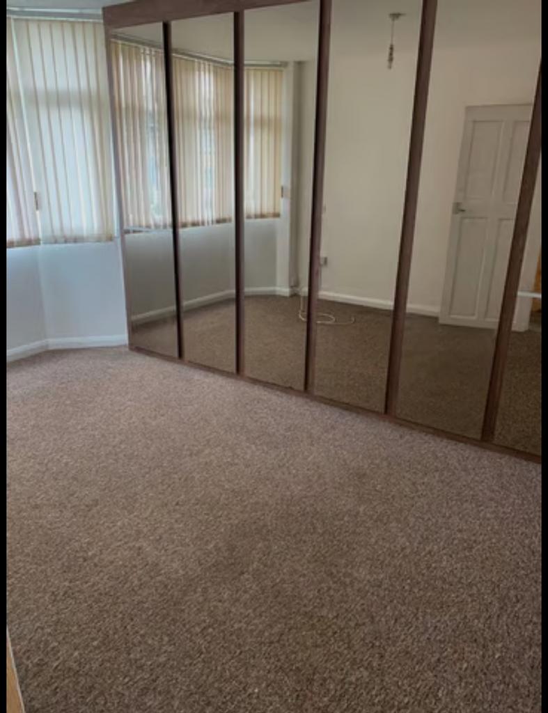 A spacious and well-lit double bedroom featurin...