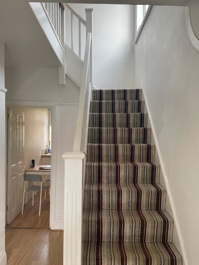 A well-maintained staircase leading to the uppe...
