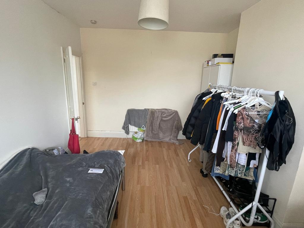 A spacious double bedroom featuring ample stora...
