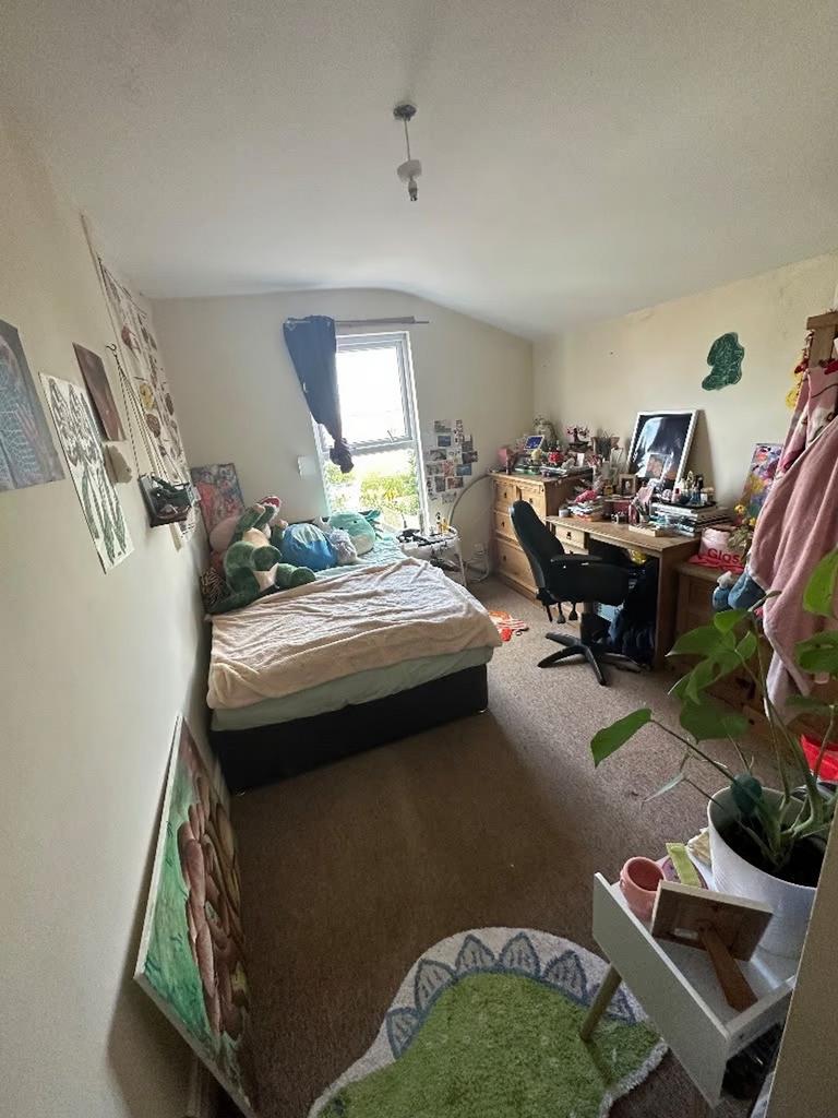 A cozy double bedroom filled with character, pe...