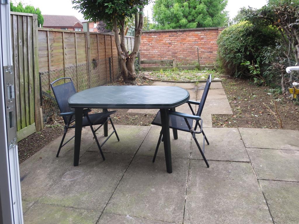 A spacious garden area with outdoor seating, pe...