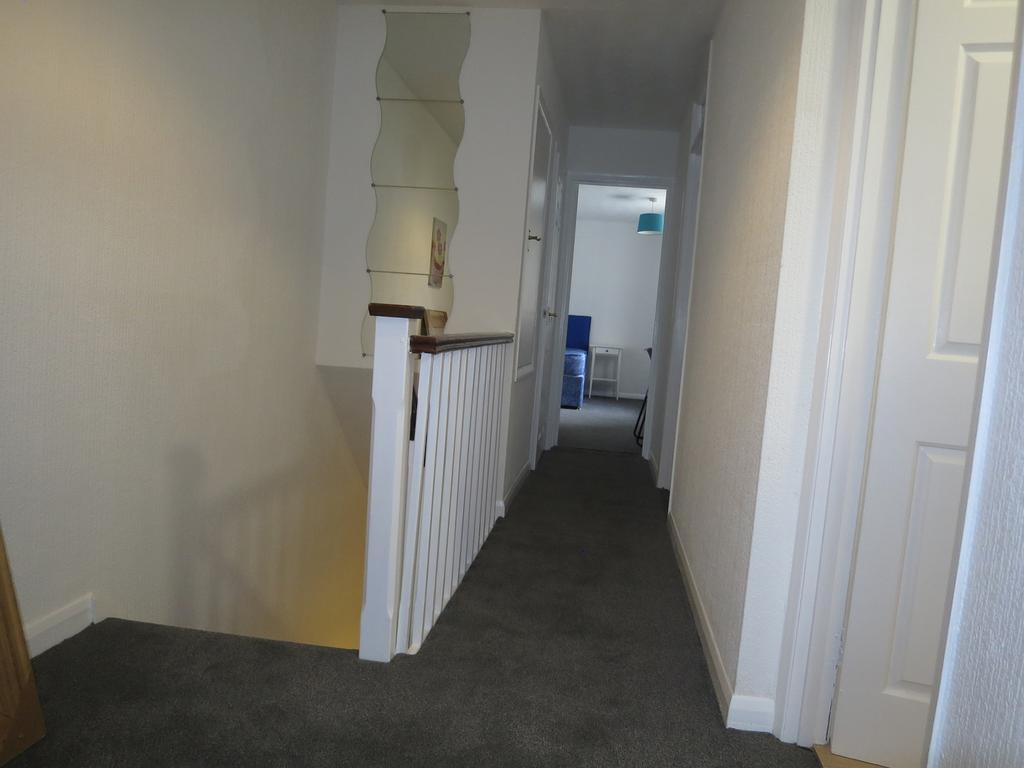 A well-maintained and tidy hallway, offering a ...