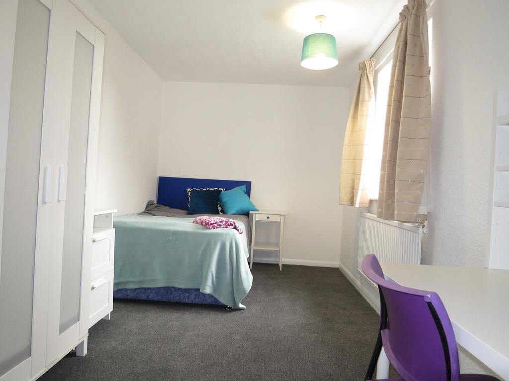 A bright and tidy double bedroom featuring a co...