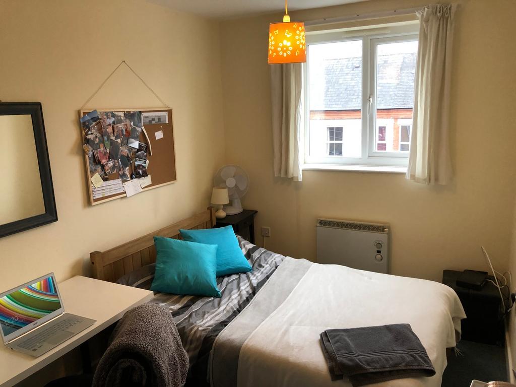 A bright and inviting double bedroom featuring ...