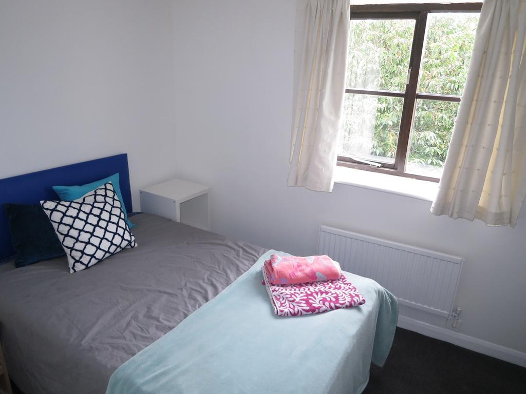 A bright and inviting double bedroom featuring ...