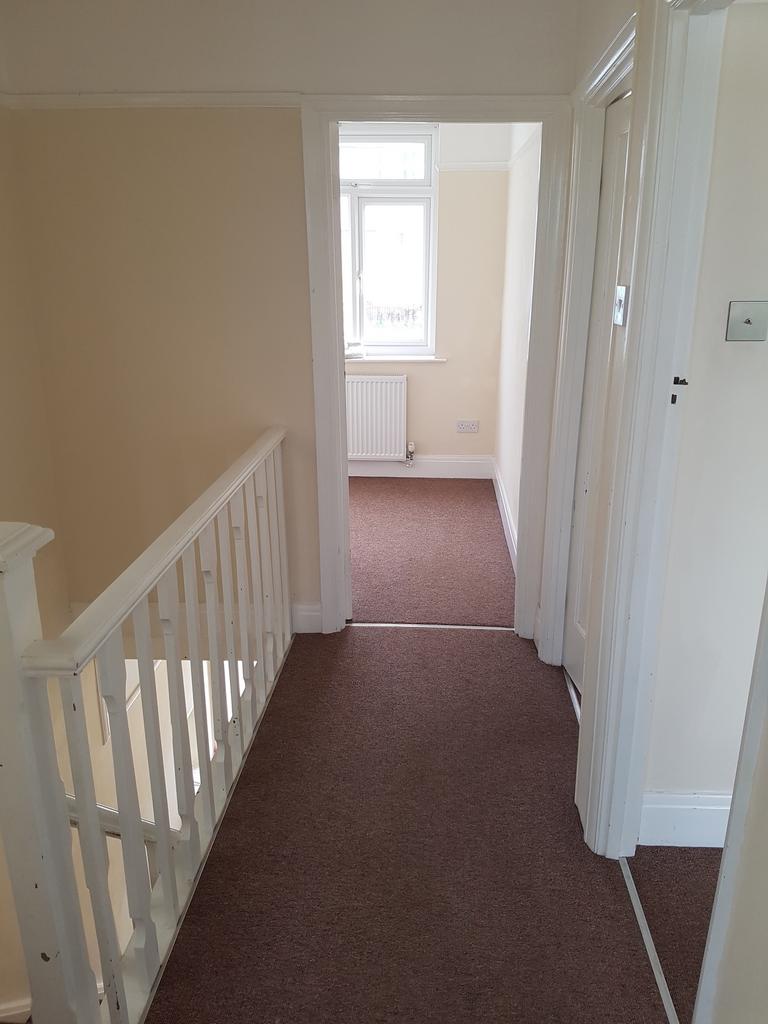 A spacious and well-maintained hallway with nat...