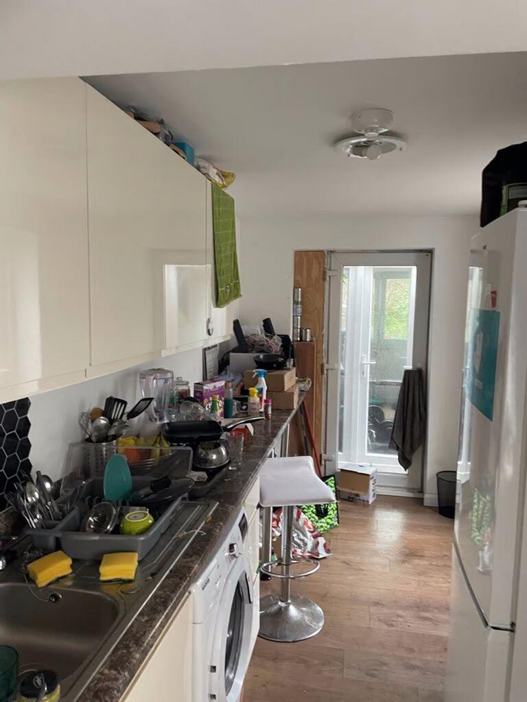 A functional kitchenette with ample storage and...