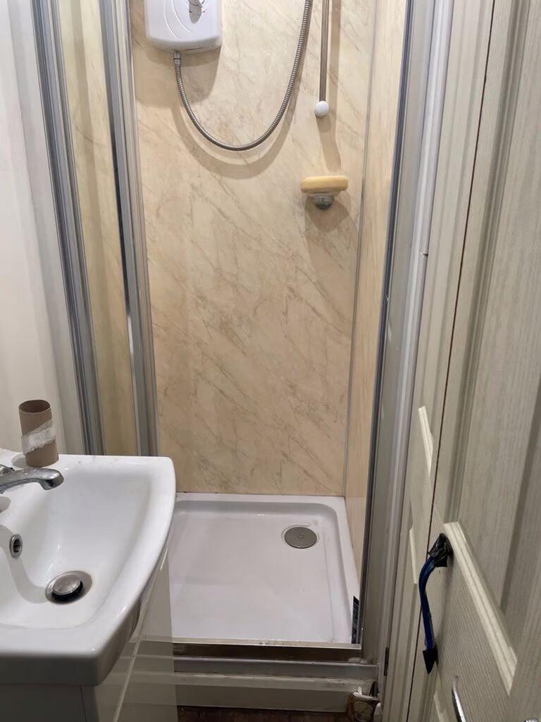 A tidy and functional bathroom with a shower, p...