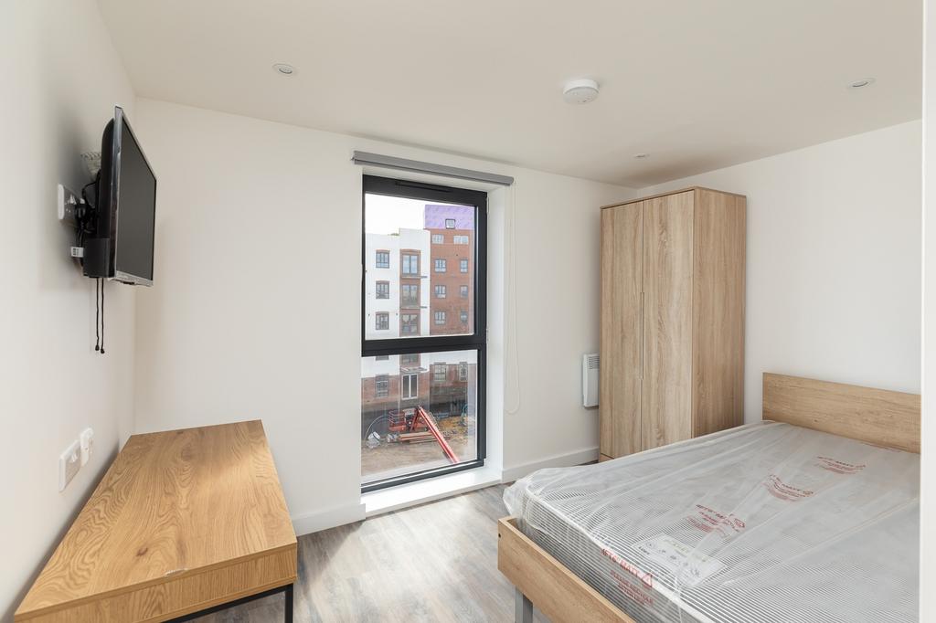 A bright and modern double bedroom featuring la...
