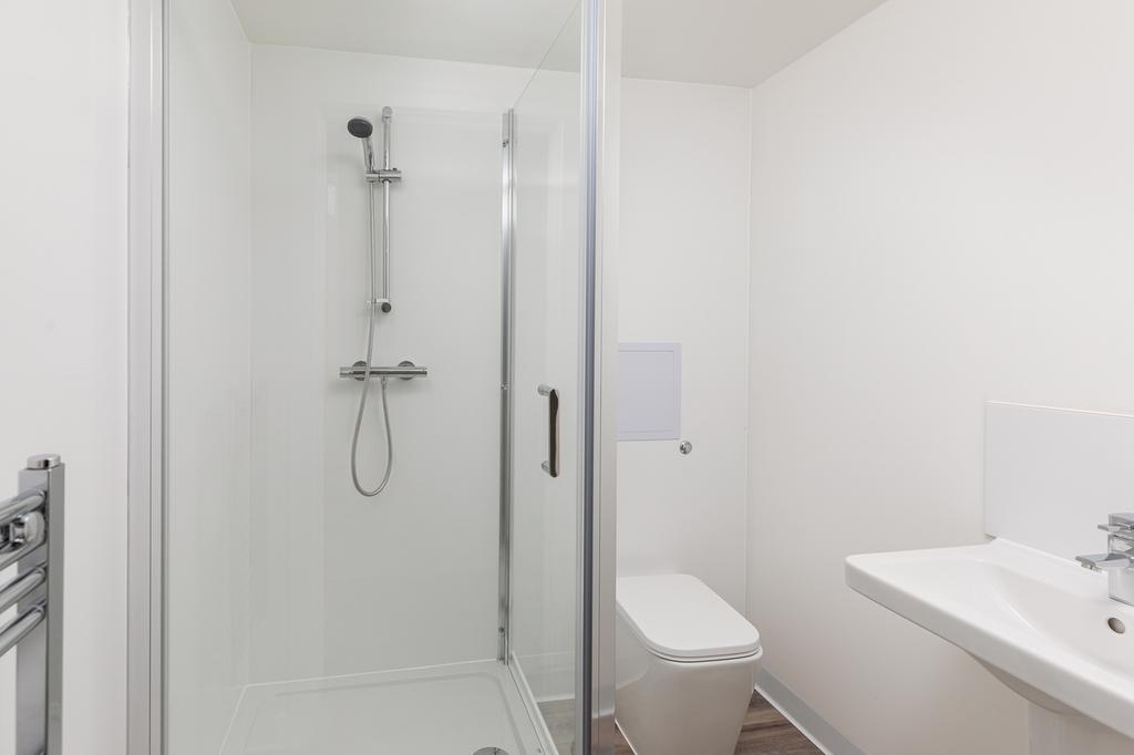 A modern and pristine bathroom featuring a spac...