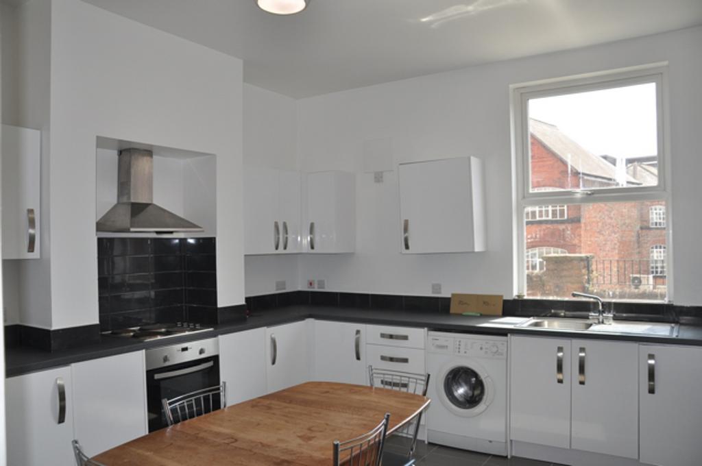 A bright and modern kitchenette featuring ample...