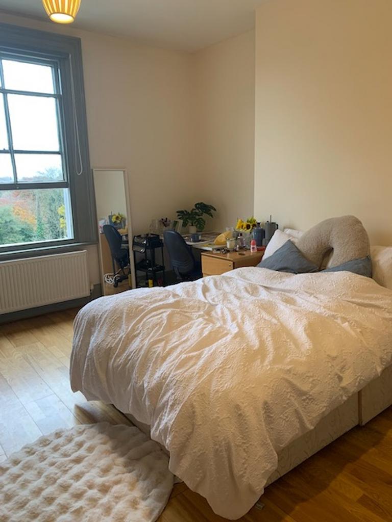 A spacious and inviting double bedroom with goo...
